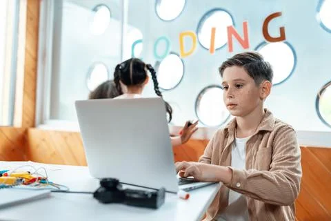 The schoolboy in classroom sitting and learn engineering with laptop. Erudition. Stockfoto's