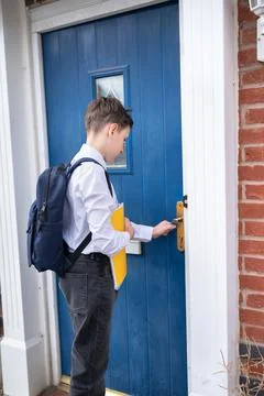 Schoolboy closing the front door with backpack. Ready back to school. Stock Photos