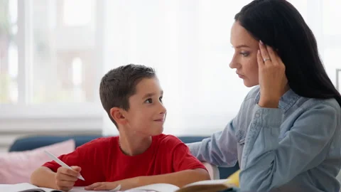 Schoolboy doing homework with mother, trying to solve difficult math problem Stock Footage 230920030