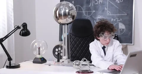 Schoolboy experimenting in physics class. Young student doing physics experiment Stock Footage 172441436
