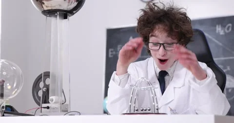 Schoolboy experimenting in physics class. Young student doing physics experiment Stock Footage 172441776