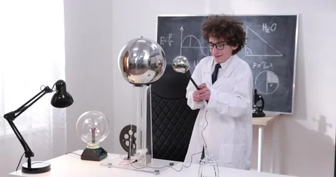 Schoolboy experimenting in physics class. Young student doing physics experiment Stock Footage 172441957