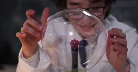 Schoolboy experimenting in physics class. Young student doing physics experiment Stock Footage 172442213