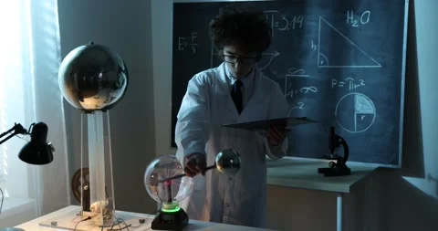 Schoolboy experimenting in physics class. Young student doing physics experiment Stock Footage 172442277