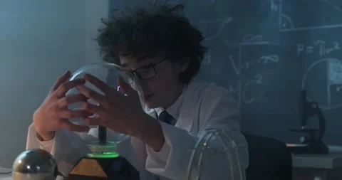 Schoolboy experimenting in physics class. Young student doing physics experiment Stock Footage 172442407