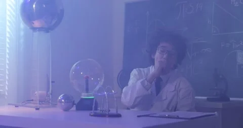 Schoolboy experimenting in physics class. Young student doing physics experiment Stock Footage 172442495