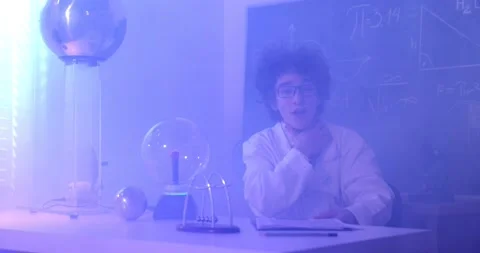 Schoolboy experimenting in physics class. Young student doing physics experiment Stock Footage 173398162