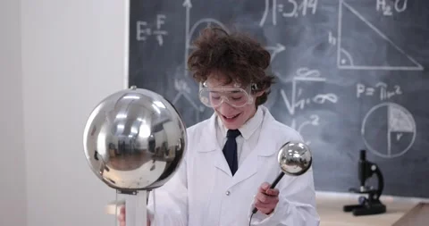 Schoolboy experimenting in physics class. Young student doing physics experiment Stock Footage 176199326