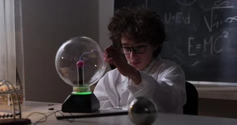 Schoolboy experimenting in physics class. Young student doing physics experiment Stock Footage 176201128