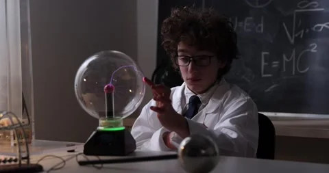 Schoolboy experimenting in physics class. Young student doing physics experiment Stock Footage 176201638