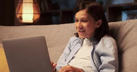 Schoolboy Expressing Amazement While Using Laptop on the Sofa Stock-Footage 254497312
