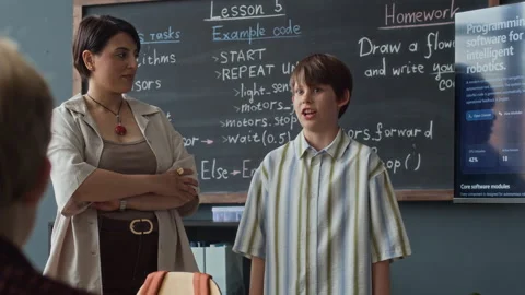 Schoolboy Giving Presentation in Robotics Class with Teacher Clapping Stock Footage 339202307