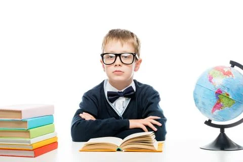Schoolboy with glasses at the table while studying Stock Photos
