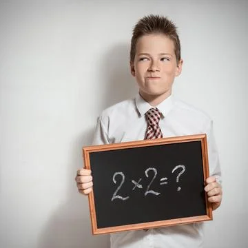The schoolboy has thought of the task decision Stock Photos