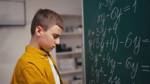 Schoolboy having difficult task, puzzled with a math problem, school education Stock Footage 250334057
