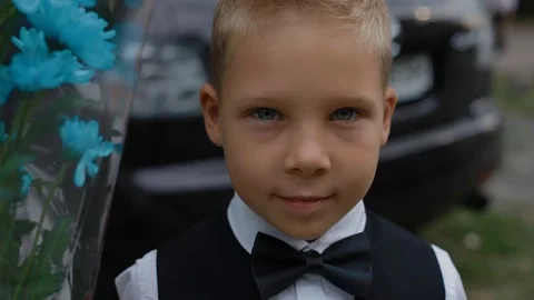 Schoolboy hold the floweers Stock Footage 70862450