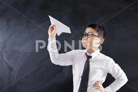 Schoolboy holds paper plane Stock Photos