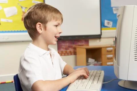 Schoolboy In IT Class Using Computer Stock Photos