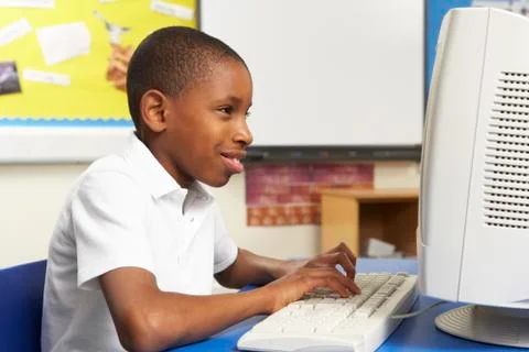 Schoolboy In IT Class Using Computer Stock Photos