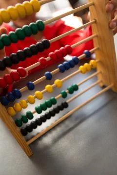 Schoolboy learning math with abacus at desk in a classroom Stock Photos