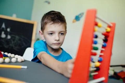 Schoolboy learning maths with an abacus Stock Photos