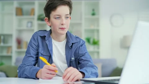 A schoolboy learns online remotely lecture by video call. Distance learning  Stock Footage 238632010