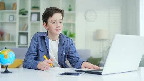 A schoolboy learns online remotely lecture by video call. Distance learning  Stock Footage 238632011