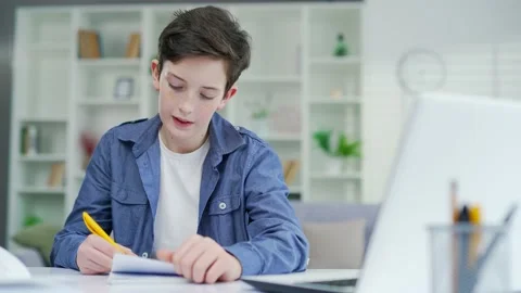 A schoolboy learns online remotely lecture by video call. Distance learning  Stock Footage 238632212
