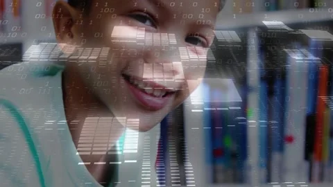 Schoolboy lifting head smiling in library as binary overlay intensifying coding Stock Footage 320287898