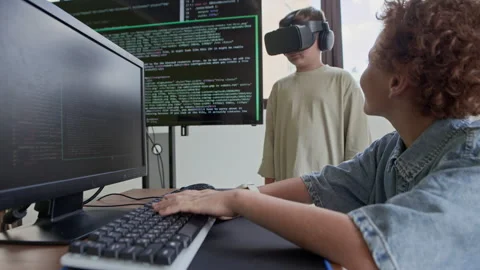 Schoolboy Looking at Classmate in VR Headset during Virtual Presentation Stock Footage 316477938