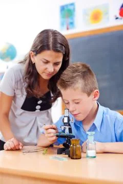Schoolboy looking into microscope Stock Photos