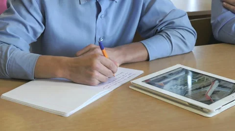 Schoolboy looks at the information using a tablet Stock Footage 68822543