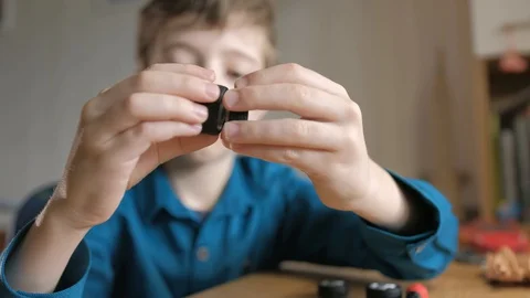Schoolboy looks to wheels off disassembled model rcar Stock Footage 129402656