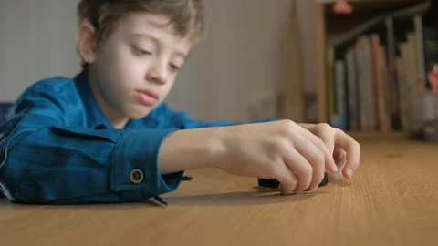 Schoolboy looks to wheels off disassembled model supercar Stock Footage 129402901