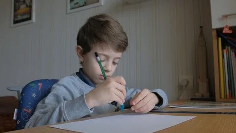 Schoolboy make homework and using drawing compass and ruler to draw a car Stock Footage 129012406