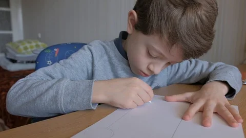 Schoolboy make homework and using drawing compass and ruler to draw a car Stock Footage 129012408