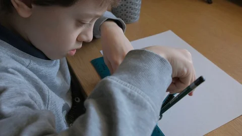 Schoolboy make homework and using drawing compass and ruler to draw a car Stock Footage 129012417