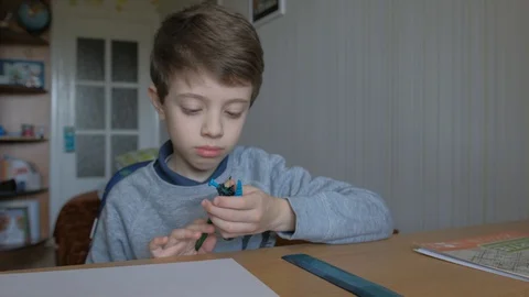 Schoolboy make homework and using drawing compass and ruler to draw a car Stock Footage 129012422