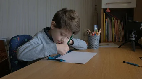 Schoolboy make homework and using drawing compass and ruler to draw a car Stock Footage 129012431
