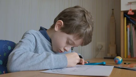 Schoolboy make homework and using drawing compass and ruler to draw a car Stock Footage 129012433