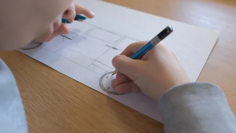 Schoolboy make homework and using drawing compass and ruler to draw a car Stock Footage 129012443
