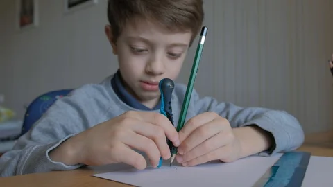 Schoolboy make homework and using drawing compass and ruler to draw a car Stock Footage 129012450