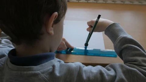 Schoolboy make homework and using drawing compass and ruler to draw a car Stock Footage 129012452