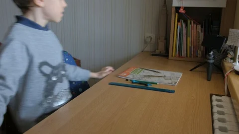 Schoolboy make homework and using drawing compass and ruler to draw a car Stock Footage 129012454