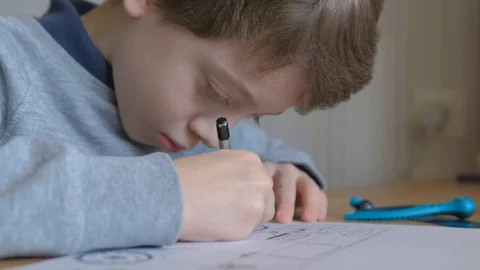 Schoolboy make homework and using drawing compass and ruler to draw a car Stock Footage 129012476
