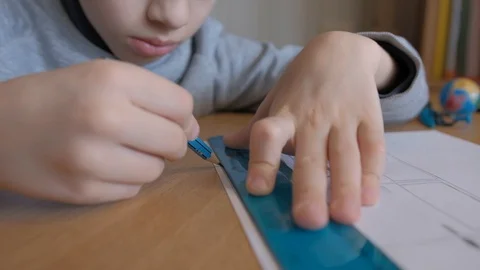 Schoolboy make homework and using drawing compass and ruler to draw a car Stock Footage 129012481