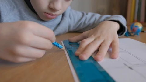 Schoolboy make homework and using drawing compass and ruler to draw a car Stock Footage 129012482