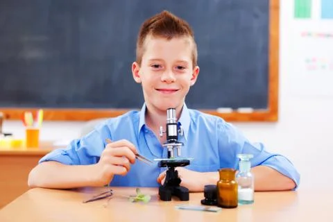 Schoolboy with microscope Stock Photos