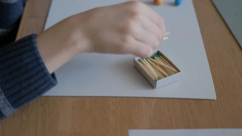 Schoolboy models the geometric shapes from plasticine and matches. Stock Footage 128988907