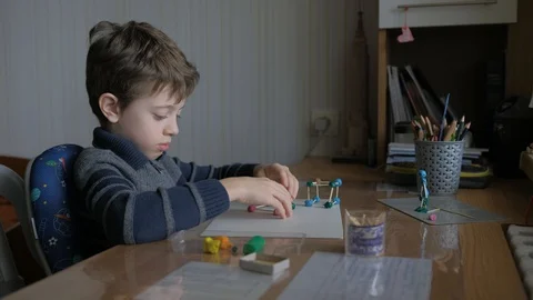 Schoolboy models the geometric shapes from plasticine and matches. Stock Footage 128988945